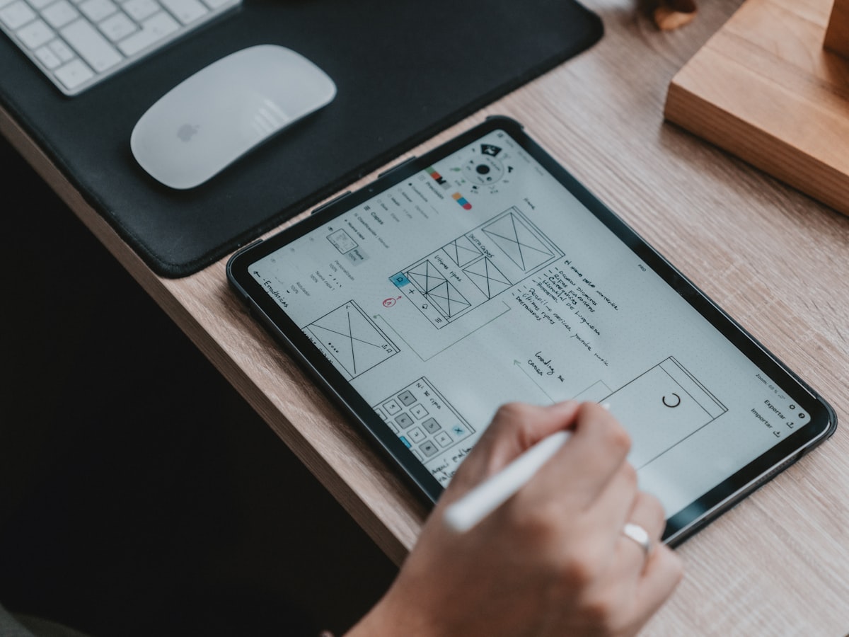 Interface wireframes drawn on a tablet