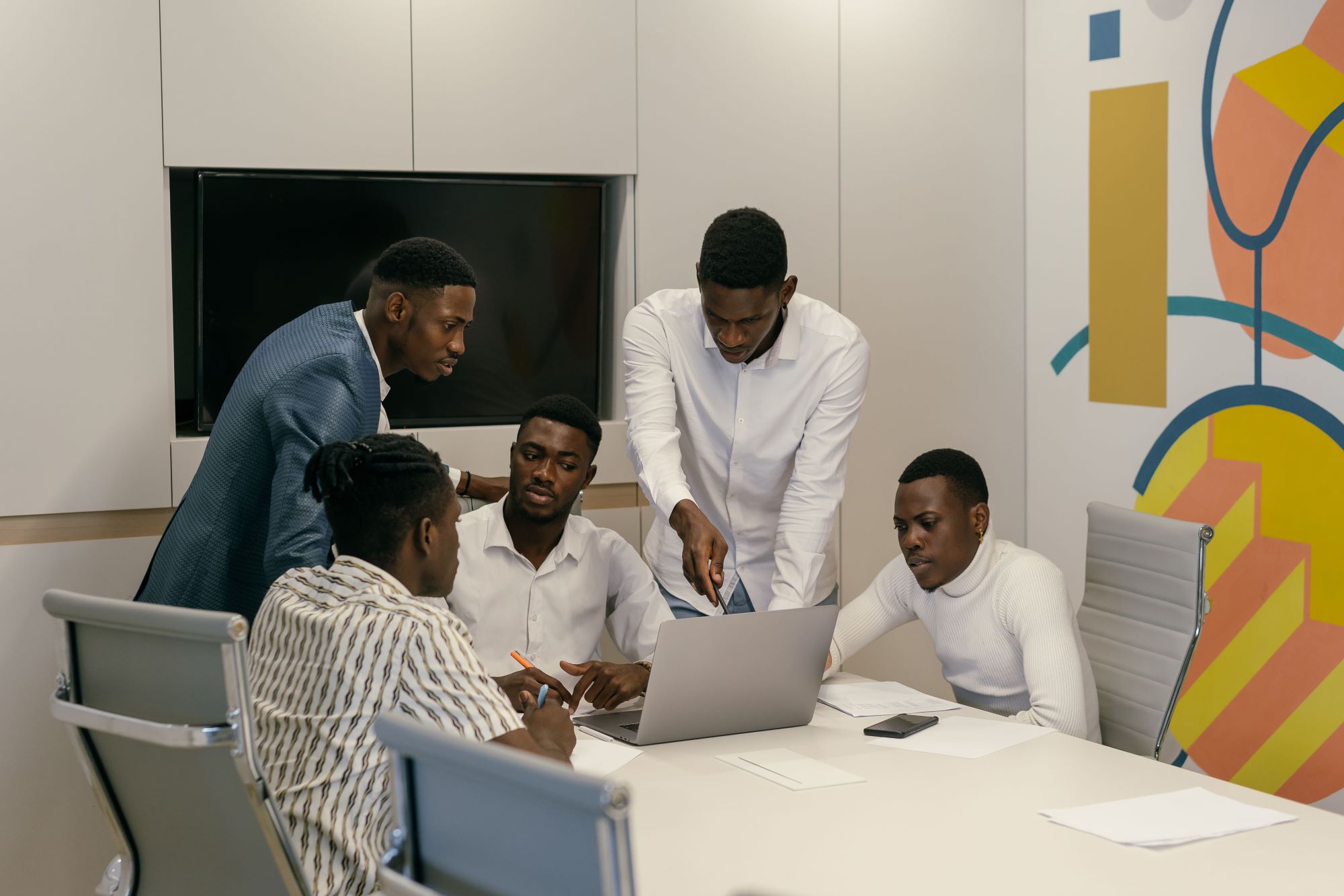 Business professionals reviewing a project on a laptop